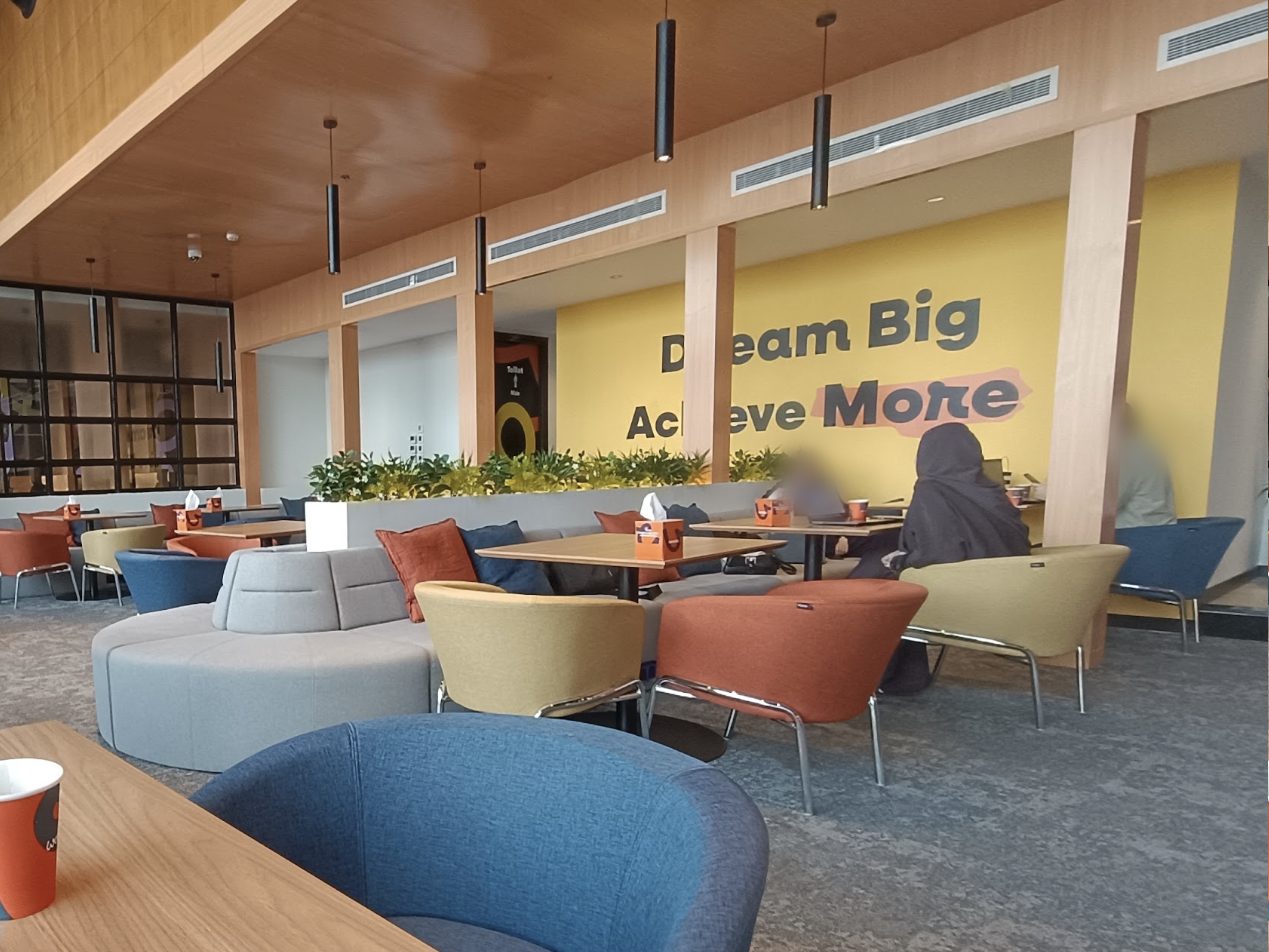 Work&Co coworking lounge with a yellow Dream Big wall